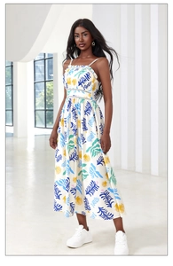 Detail of white sleeveless maxi dress with blue and yellow tropical leaf prints