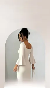 Detailed view of the square neckline and elegant bell sleeves on this apricot midi dress