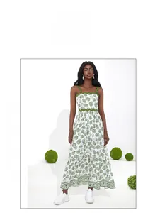 Detailed view of white floral dress with green scalloped edges and coral print patterns