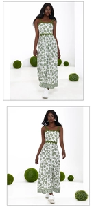 Detail of white maxi dress featuring green coral print and wavy scallop lace trimmings