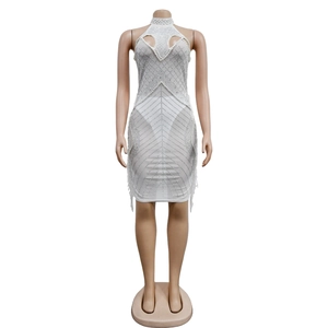 Detail of white mesh mini dress featuring rhinestones, pearls and teardrop neckline cutout
