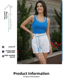 Detail of white high-waist cotton shorts featuring blue and white rope belt accessory