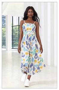 Detailed view of digital leaf print on white sleeveless summer dress with lace trim