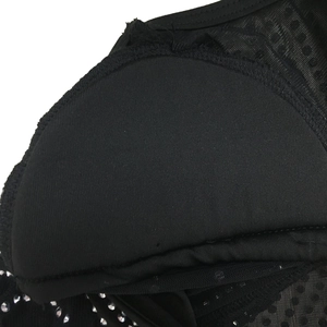 Detail of black mesh fabric with silver rhinestones and scalloped edge on dress