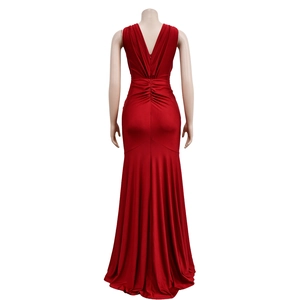 Close-up of the deep V-back and gathered ruched details on a red satin evening dress