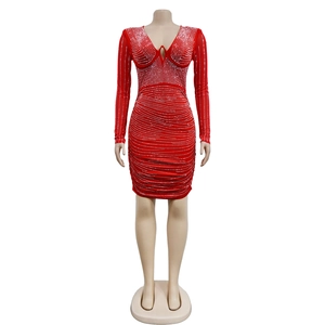 Detail of red mesh bodycon mini dress featuring silver rhinestones and deep V-neckline