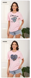 Close-up of pink cotton t-shirts featuring heart patterns with Paris and sea motifs