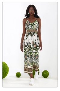 Detail of bohemian floral maxi dress with vibrant leaf prints and beaded shoulder straps
