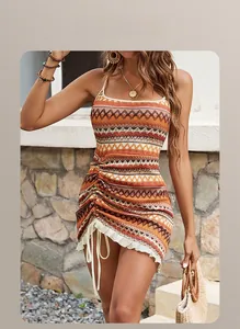Detail of bohemian knit dress with zigzag patterns and adjustable side drawstring hem