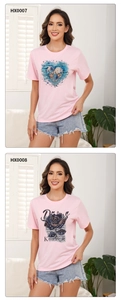 Detail view of two pink round neck T-shirts with heart shell and floral rose prints