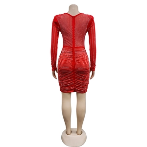 Detail of red bodycon dress featuring silver rhinestones and a back hidden zipper