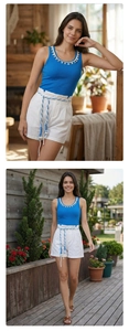 Detail of blue ribbed tank top with shell decor and white shorts with woven belt