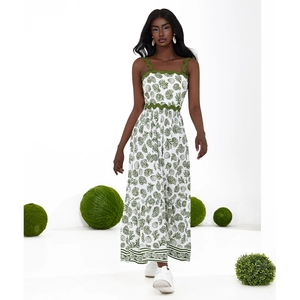 Summer maxi dress with green coral print and wavy trim detailing on white fabric
