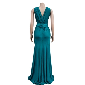 Detail of emerald green V-back maxi dress with elegant ruching and mermaid silhouette