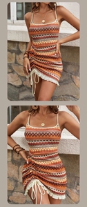 Detailed view of bohemian striped knit dress featuring side drawstring and ruffle hem