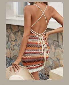 Detailed view of bohemian knit dress with zigzag patterns and crisscross back ties
