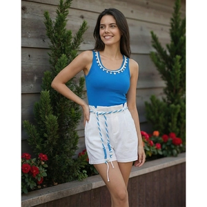 Women's blue shell-neck tank top and white high-waist shorts with braided belt