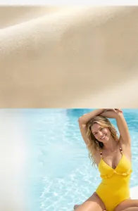 Detailed fabric texture of yellow lace swimsuit with 95% polyester and 5% spandex blend