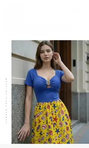 Detail of cutout metal ring on royal blue bodice with ocean starfish print skirt