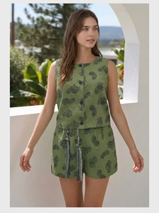 Detail of bohemian olive green paisley print two-piece set featuring textured fabric and buttons