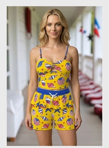 Detail of nautical starfish prints and metal ring cutout on yellow summer two-piece set