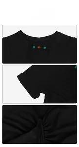 Close-up of V-neck hollow-out design with colored beads and ruched hem on black T-shirt