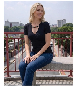 Detail of deep V-neckline with decorative colorful beads on a black slim-fit T-shirt
