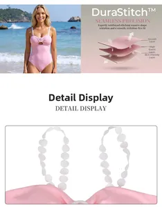 Detail of pink one-piece swimsuit featuring white scalloped straps and O-ring cutout design