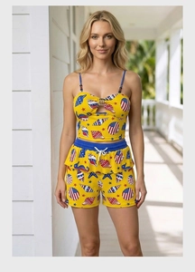 Detail of yellow beachwear set with sea shells and patriotic patterns on ruffle shorts