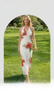 Detail of red lily digital print and sheer mesh fabric on a slimming maxi dress