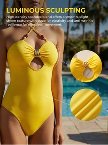 Close-up of yellow halter swimsuit showing cutout detail and metallic ring embellishment
