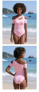 Detail of pink one-shoulder bodysuit with metal eyelets on sleeve at the beach