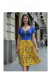 Detail of blue cut-out top with golden ring and yellow ocean print skirt