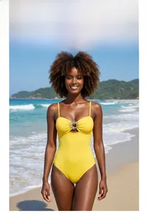 Detail of yellow one-piece swimsuit featuring a sun-shaped metal buckle and thin straps