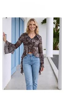 Detail of V-neck lace top with abstract brown print, ruffles, and flared sleeve style
