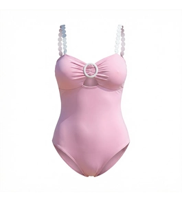 Close-up of pink swimsuit with white ring detail, cutout, and polka dot chain straps
