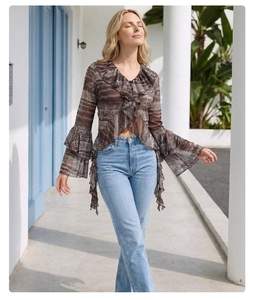 Detail view of V-neck lace mesh blouse with brown abstract print and layered ruffles