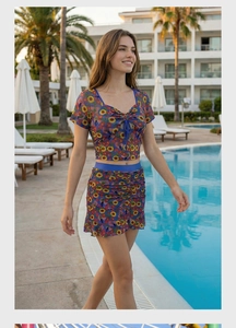 Detail of sunflower and flag print on a two-piece ruffled crop top and skirt set