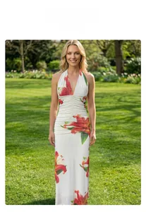 Detail of red lily floral print and ruched waist on white halter neck maxi dress
