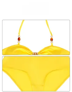 Detail view of beaded halter straps and stitching on a yellow cutout swimsuit