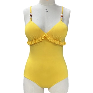Yellow V-neck one-piece swimsuit with ruffled trim and beaded strap details on white mannequin