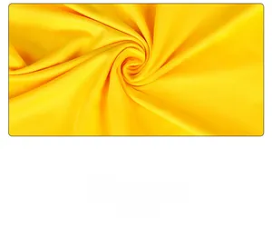 Detailed view of yellow satin swimsuit fabric with elegant spiral pleats and high-gloss texture