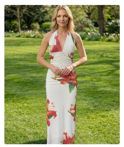Detail view of deep V-neckline and ruched waist on white lily print halter maxi dress
