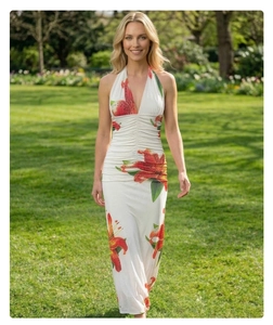 Detailed close-up of white halter neck dress with red lily print and waist pleats