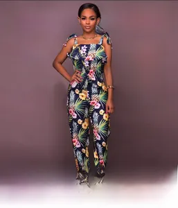 Detailed view of tropical pineapple and hibiscus floral print on strapless ruffle jumpsuit