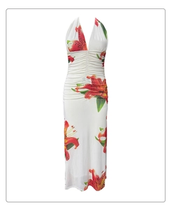 Detail of red lily print and ruched waist on a white halter neck maxi dress