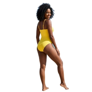 Yellow one-piece swimsuit with V-neck and thin straps on a model with white background