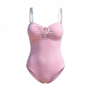 Pink one-piece swimsuit featuring scalloped straps and front cutout with ring detail