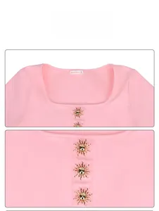 Detail view of pink square neck swimsuit with golden sun buttons and brand label