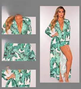 Detail view of tropical palm leaf print maxi dress with deep V-neck and high waist slit